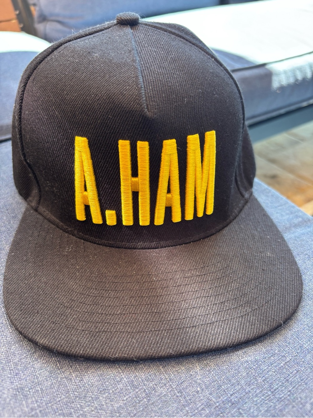 Black Snapback Hat with Bold Yellow Embroidery